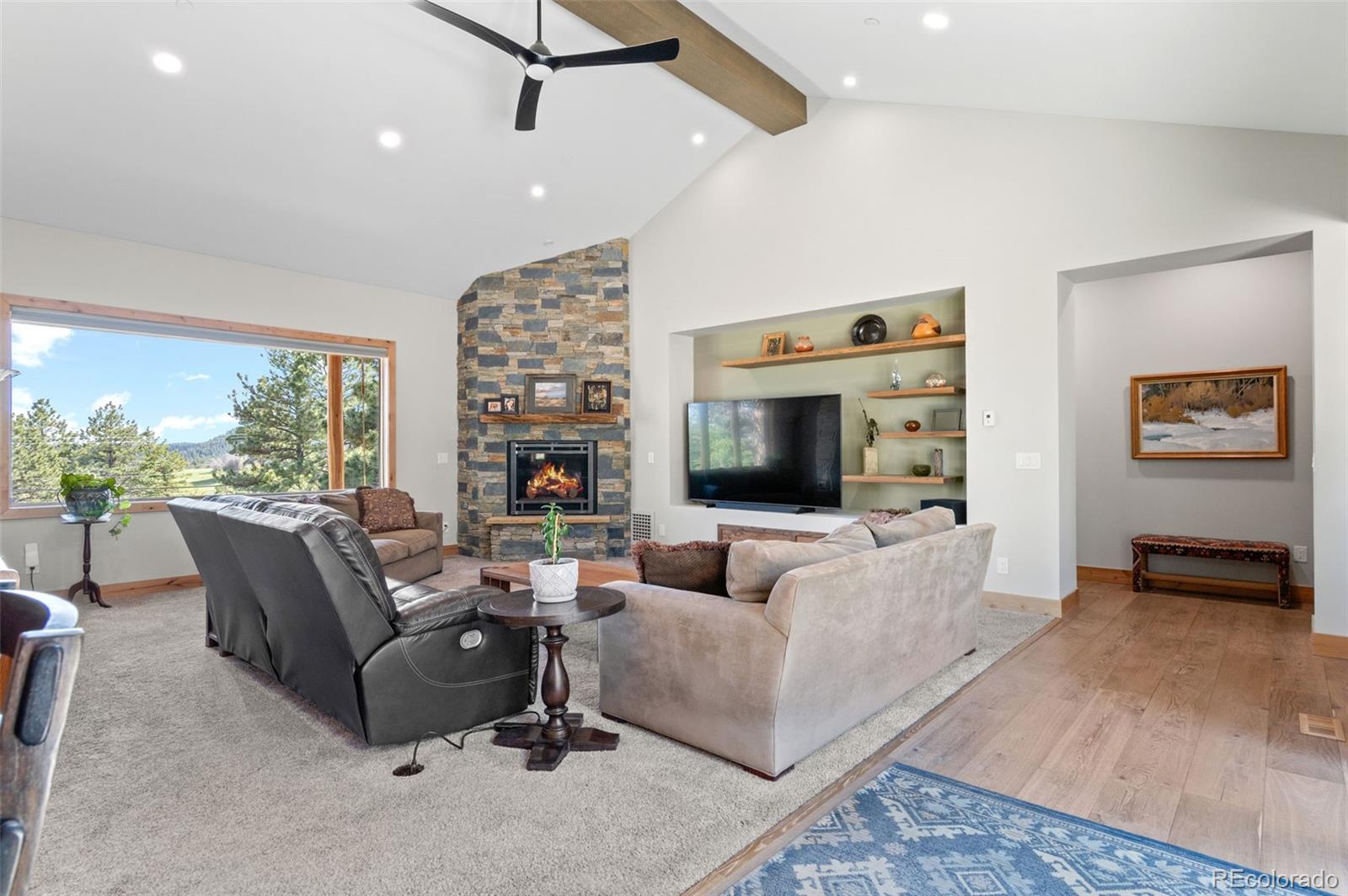 25350 Ridge Way Golden, CO 80401 - Photo 10 of 47 a living room with furniture a flat screen tv and a large window