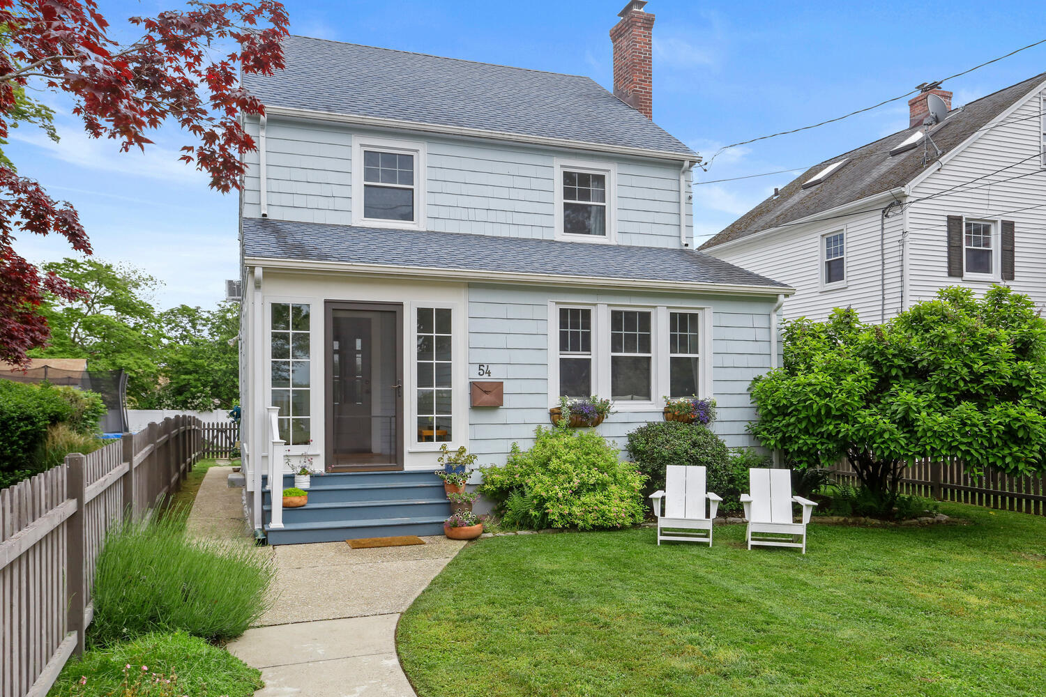 54 Ridgewood Avenue Stamford, CT 06907 - Photo 1 of 31 a front view of a house with a yard and potted plants
