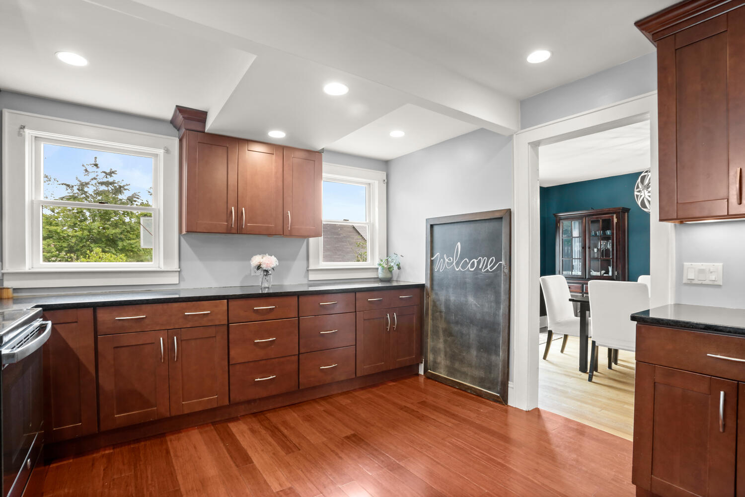 54 Ridgewood Avenue Stamford, CT 06907 - Photo 11 of 31 a kitchen with stainless steel appliances granite countertop a refrigerator a sink dishwasher and wooden cabinets with wooden floor