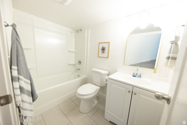 1404 East Rustic Wood Court Sandy, UT 84092 - Photo 30 of 33 Bathroom featuring a white bathtub and shower surround, white vanity with integrated sink, chrome faucet, and a wall-mounted arched mirror