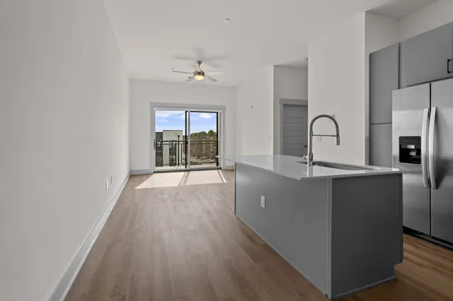 a view of a kitchen with a sink wooden floor and windows