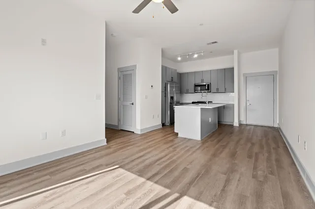 a view of kitchen with sink and wooden floor