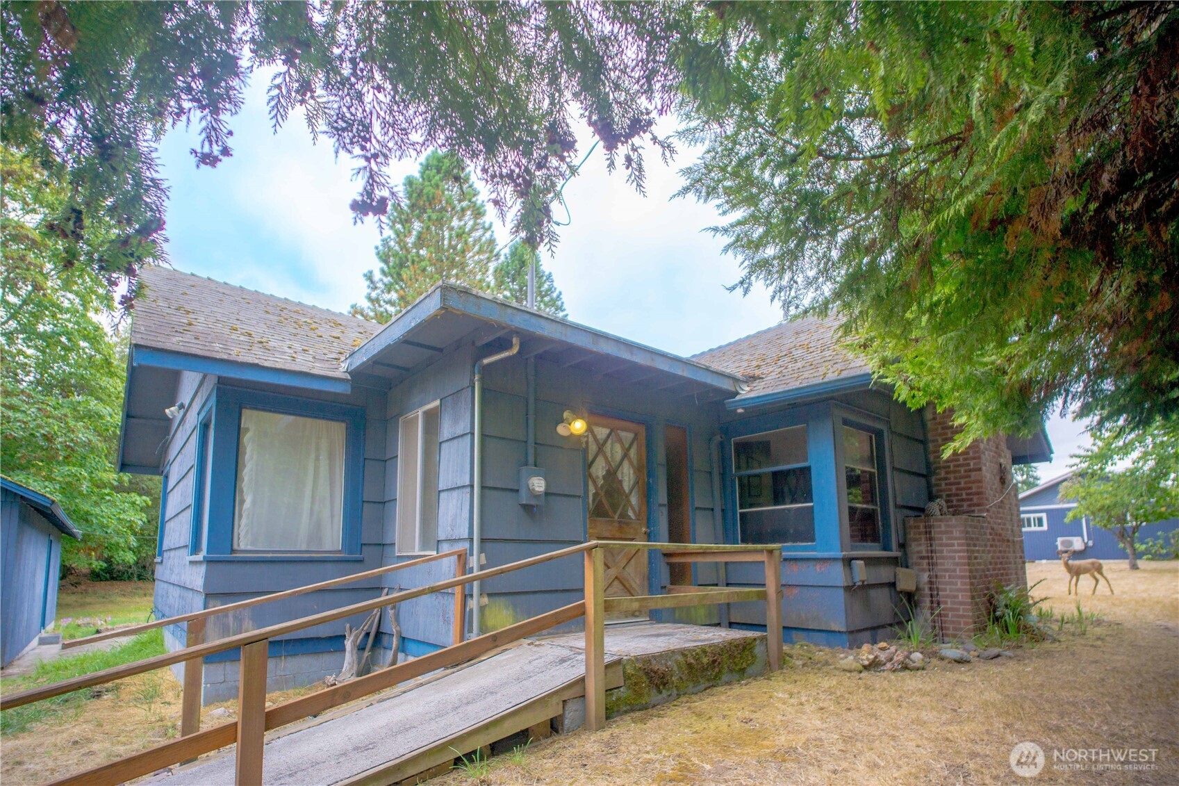 1122 West Spruce Street Port Angeles, WA 98363 - Photo 2 of 30 a view of house with a large window and a tree