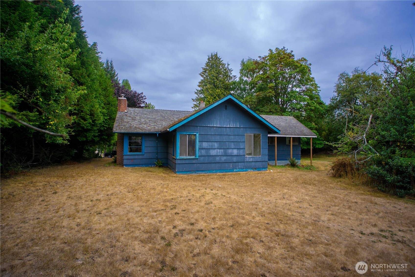 1122 West Spruce Street Port Angeles, WA 98363 - Photo 23 of 30 a view of a house with wooden fence and trees
