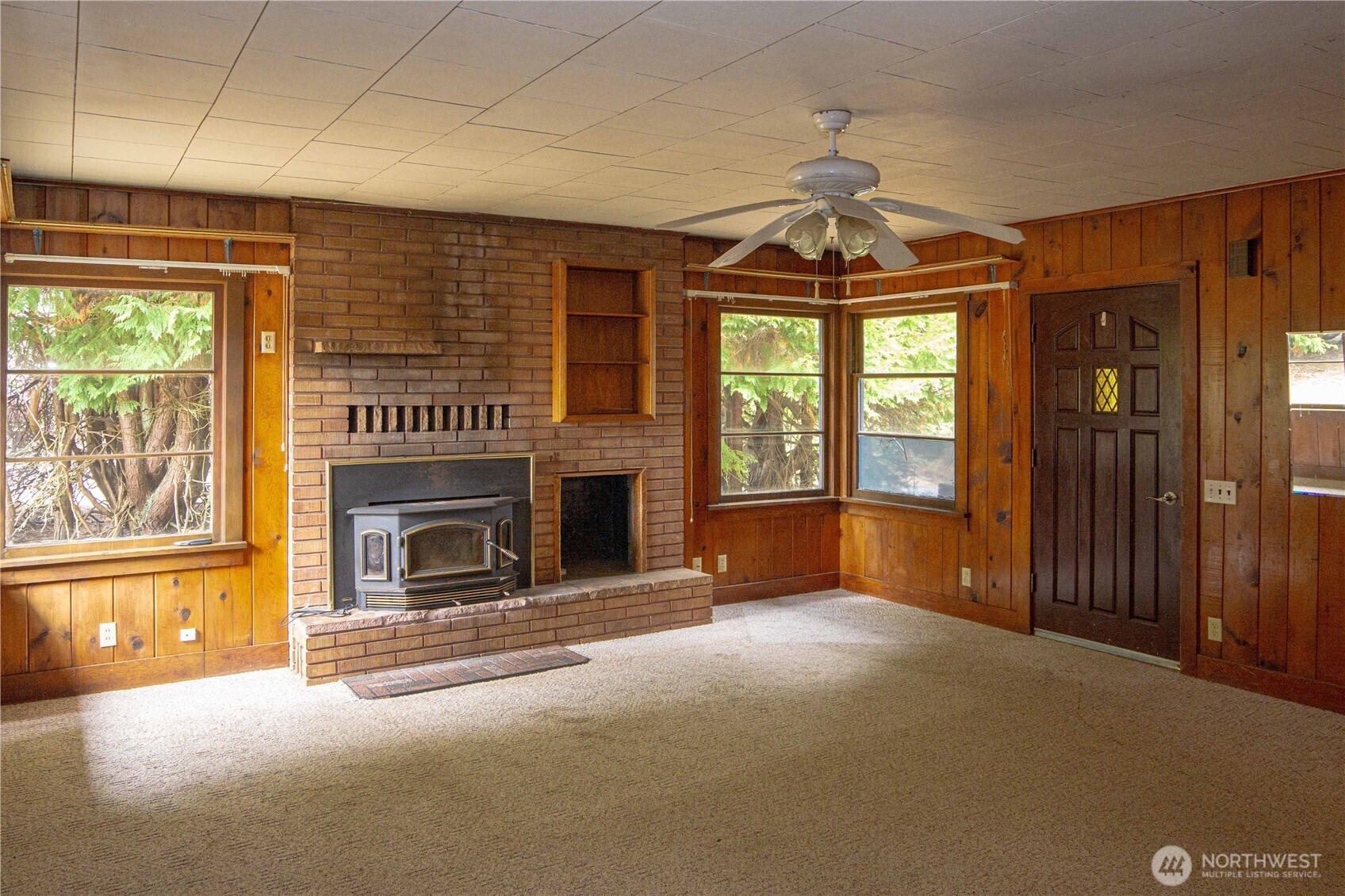 1122 West Spruce Street Port Angeles, WA 98363 - Photo 3 of 30 a view of an empty room with a fireplace and a window