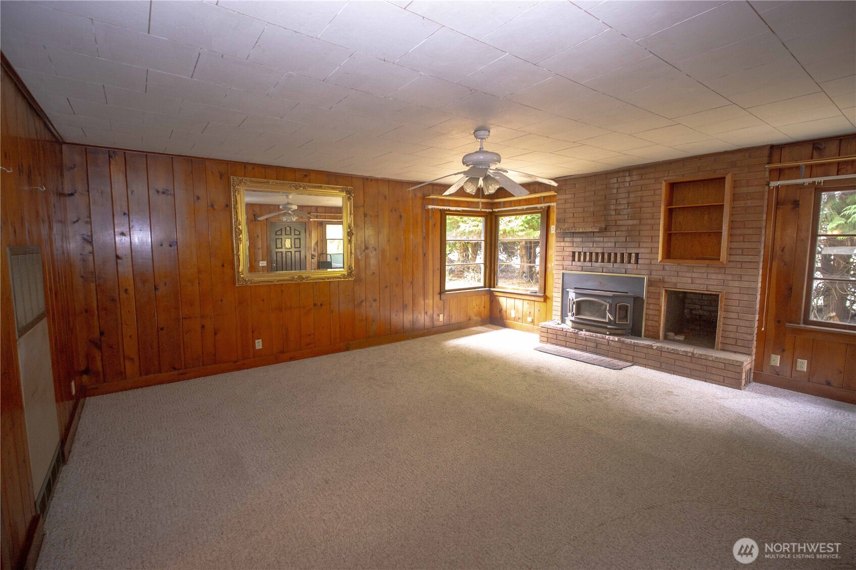 1122 West Spruce Street Port Angeles, WA 98363 - Photo 4 of 30 an empty room with windows and fireplace