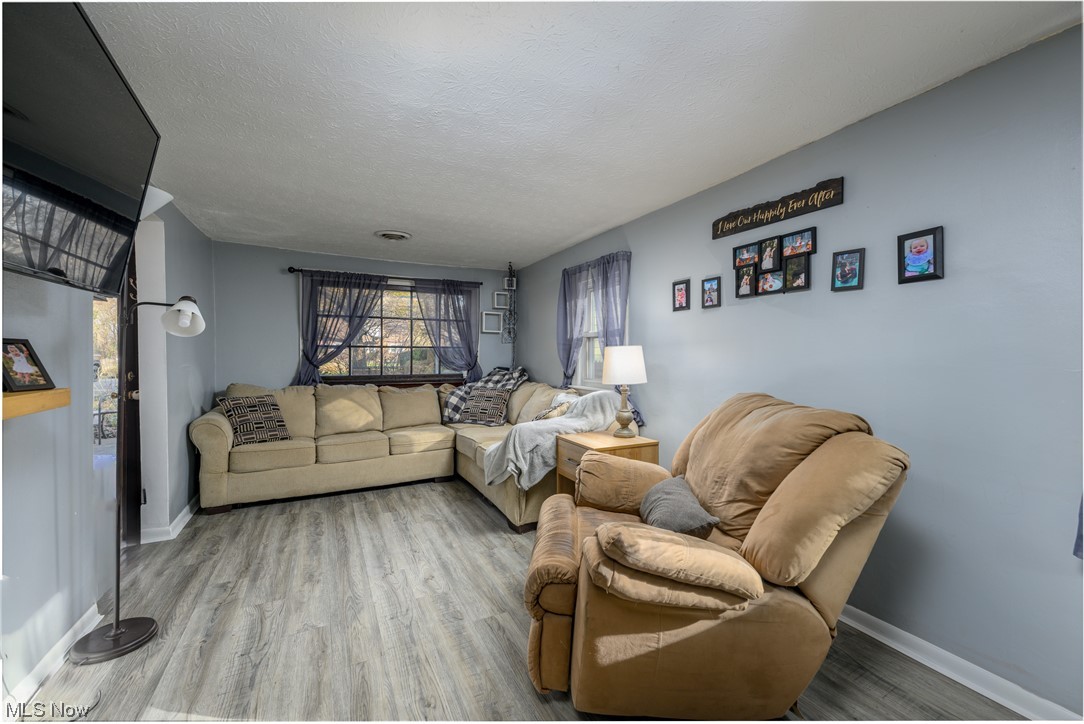 2996 Derling Road Akron, OH 44319 - Photo 8 of 19 Living room with a textured ceiling and light hardwood / wood-style floors