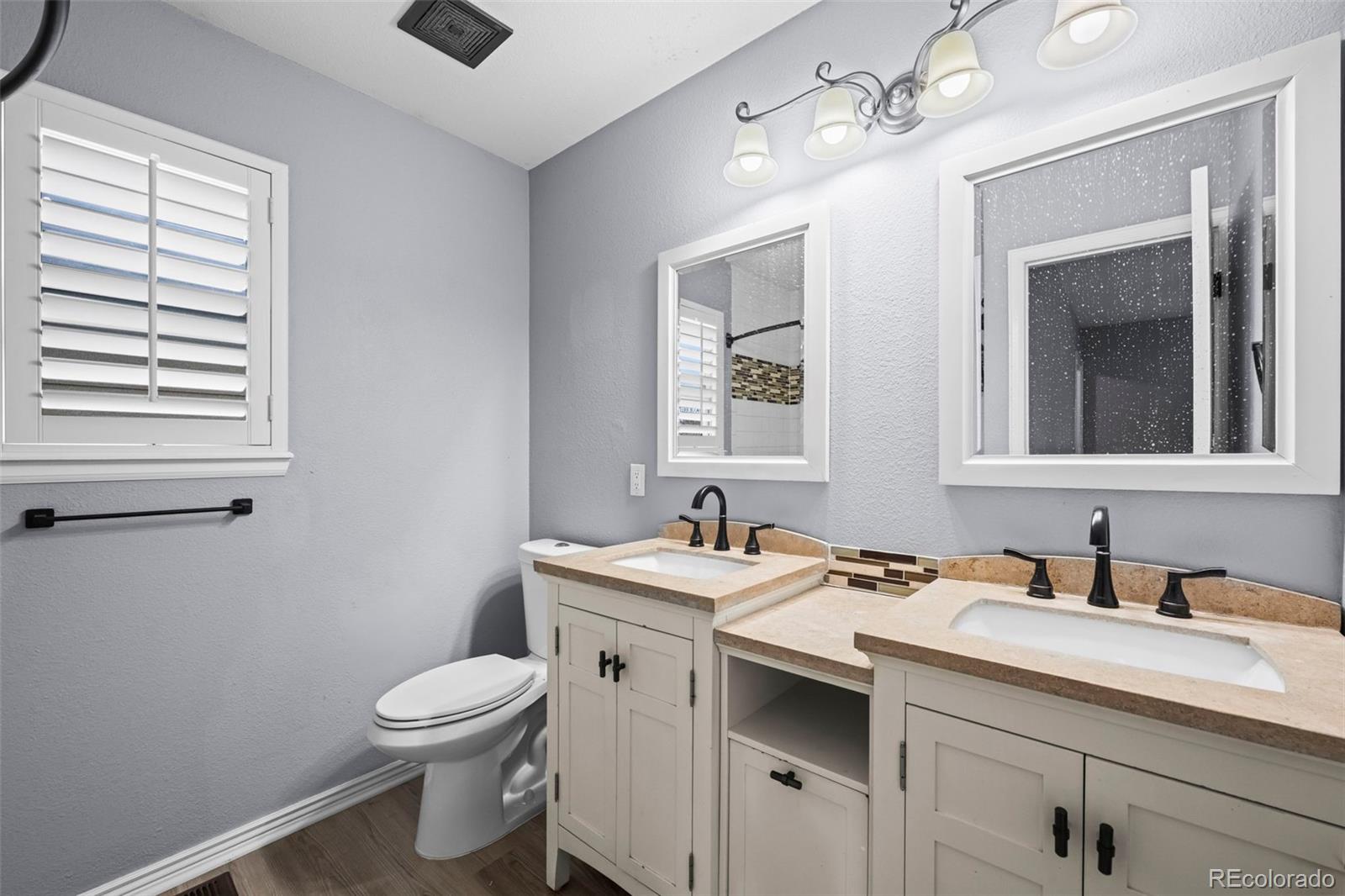 9664 Whitecliff Place Highlands Ranch, CO 80129 - Photo 16 of 46 a bathroom with a toilet sink and mirror