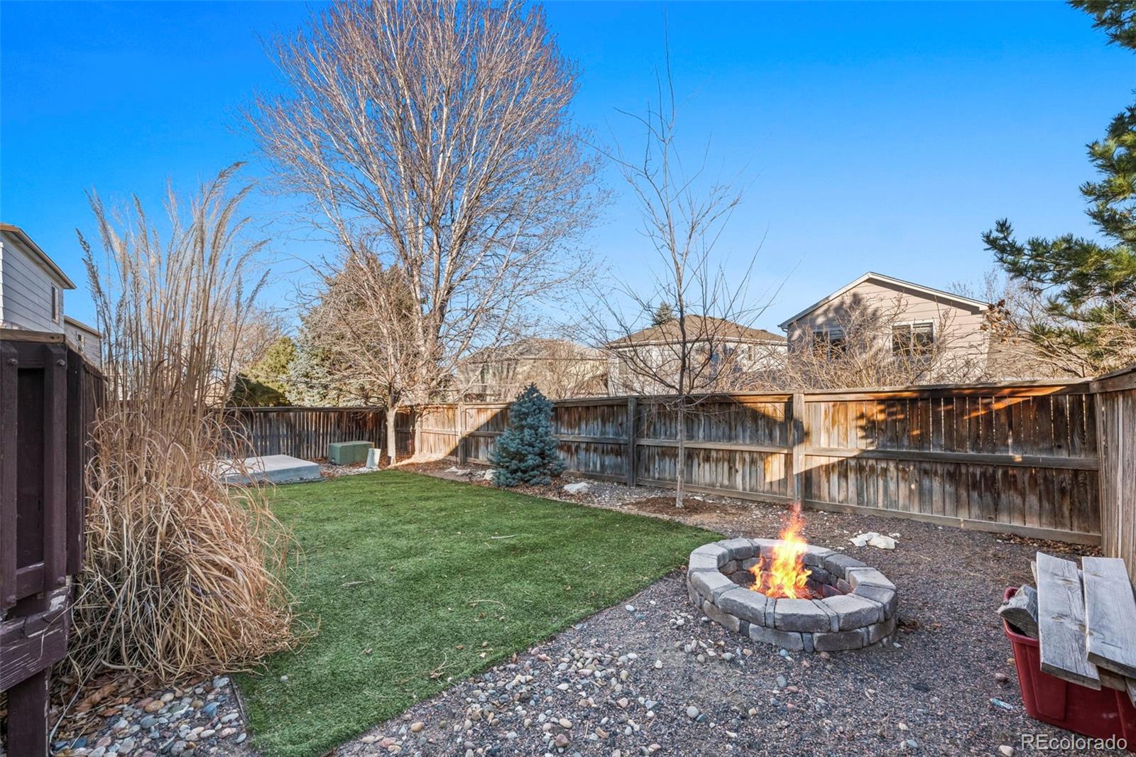 9664 Whitecliff Place Highlands Ranch, CO 80129 - Photo 18 of 38 a view of a backyard with sitting area and fire pit