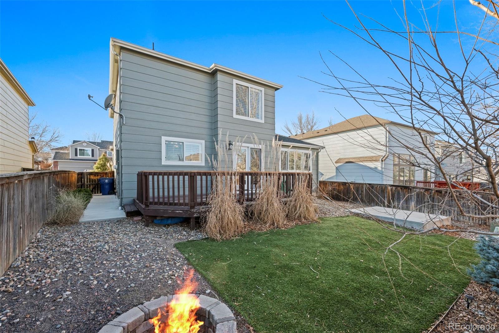 9664 Whitecliff Place Highlands Ranch, CO 80129 - Photo 19 of 38 a view of a house with a yard and wooden fence