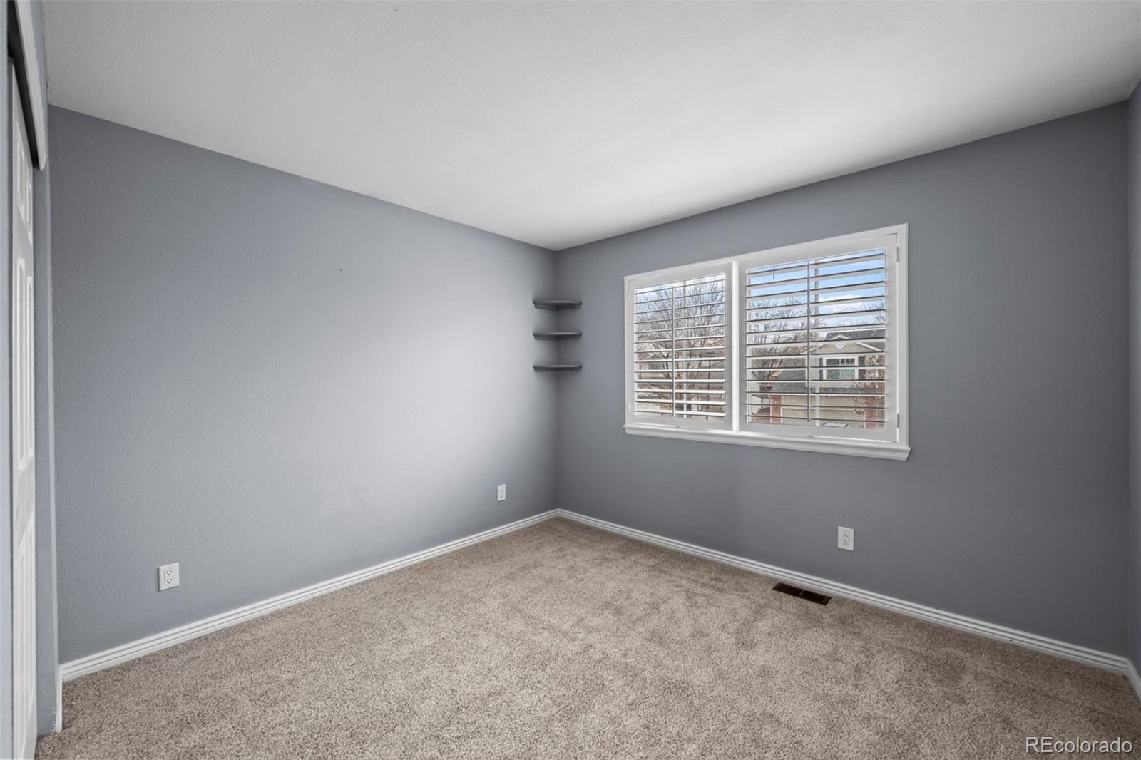 9664 Whitecliff Place Highlands Ranch, CO 80129 - Photo 19 of 46 an empty room with windows