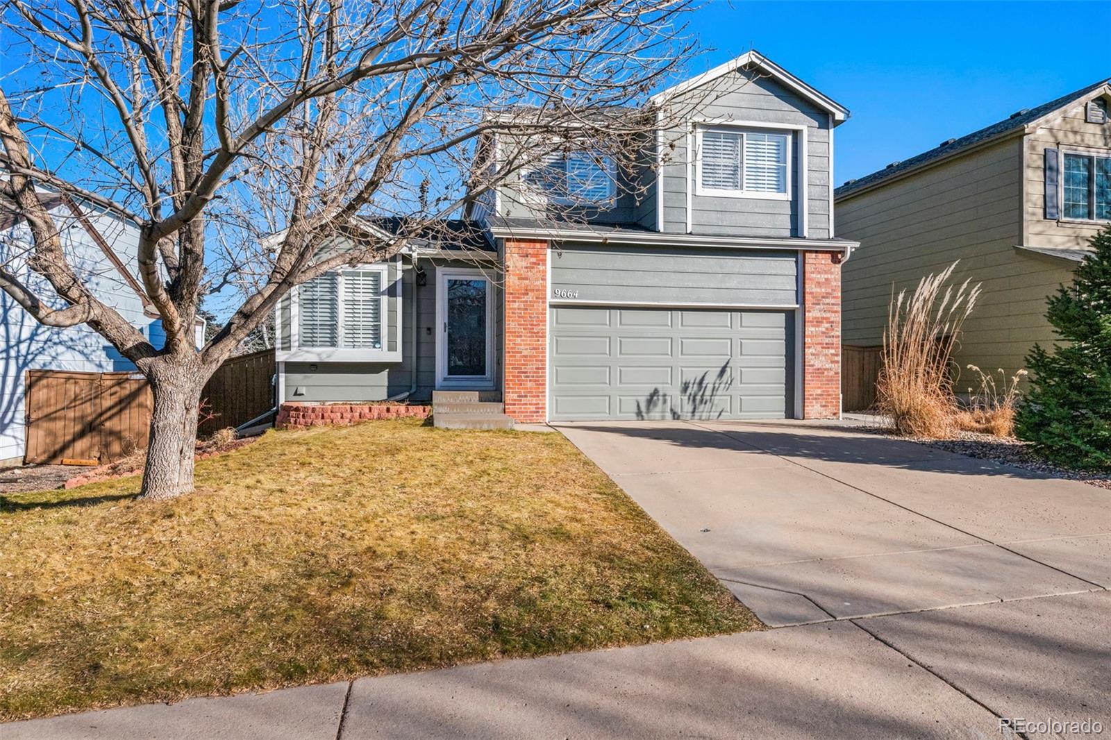 9664 Whitecliff Place Highlands Ranch, CO 80129 - Photo 2 of 38 a front view of a house with a yard