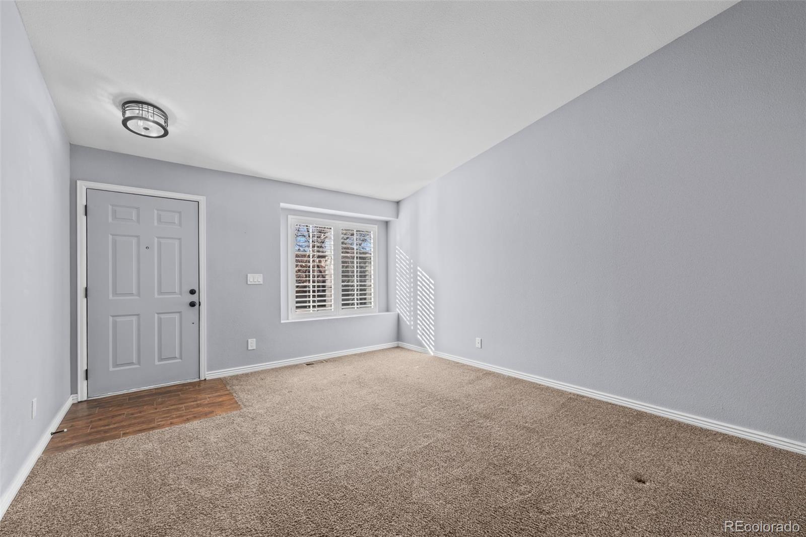 9664 Whitecliff Place Highlands Ranch, CO 80129 - Photo 3 of 38 an empty room with windows