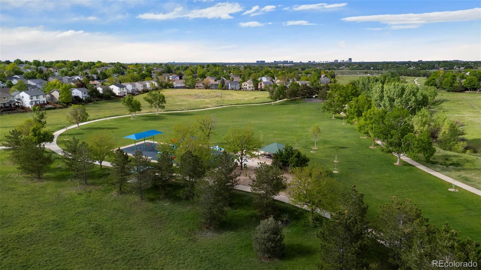 9664 Whitecliff Place Highlands Ranch, CO 80129 - Photo 31 of 38 a view of a lake with a city