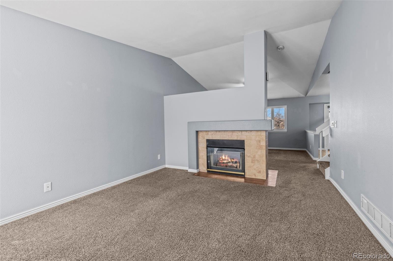 9664 Whitecliff Place Highlands Ranch, CO 80129 - Photo 4 of 38 a view of an empty room with a fireplace
