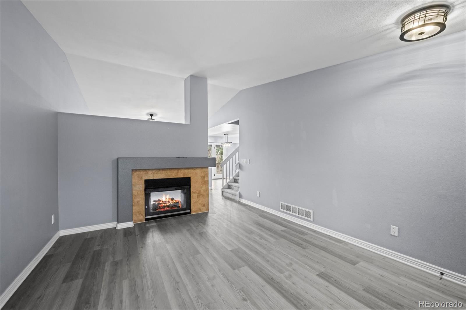 9664 Whitecliff Place Highlands Ranch, CO 80129 - Photo 4 of 46 a view of an empty room with wooden floor and a window