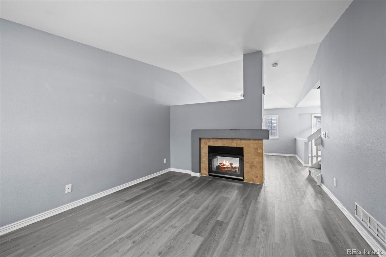 9664 Whitecliff Place Highlands Ranch, CO 80129 - Photo 5 of 46 a view of an empty room with a fireplace and a window