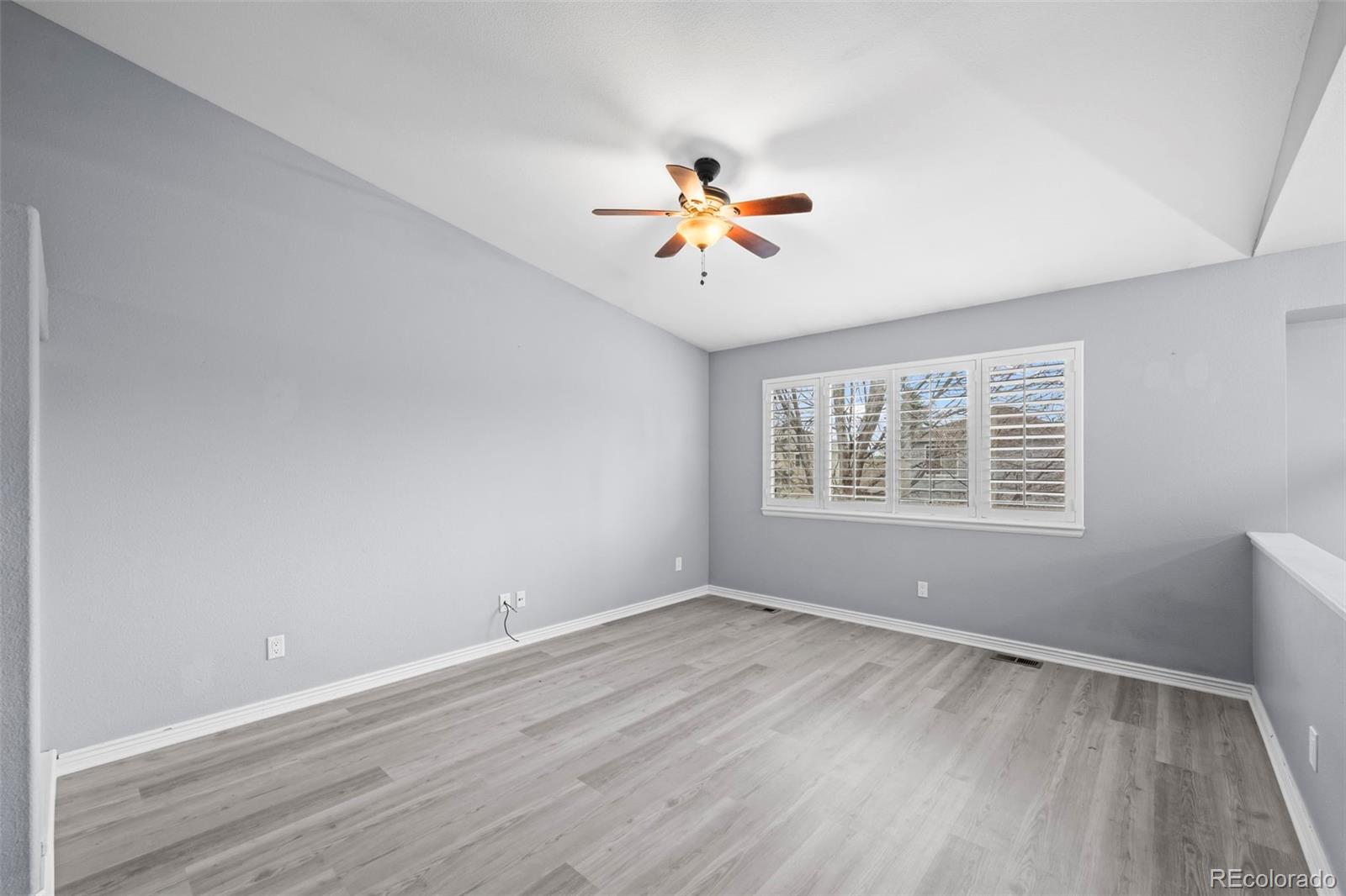 9664 Whitecliff Place Highlands Ranch, CO 80129 - Photo 7 of 46 wooden floor in an empty room with a window