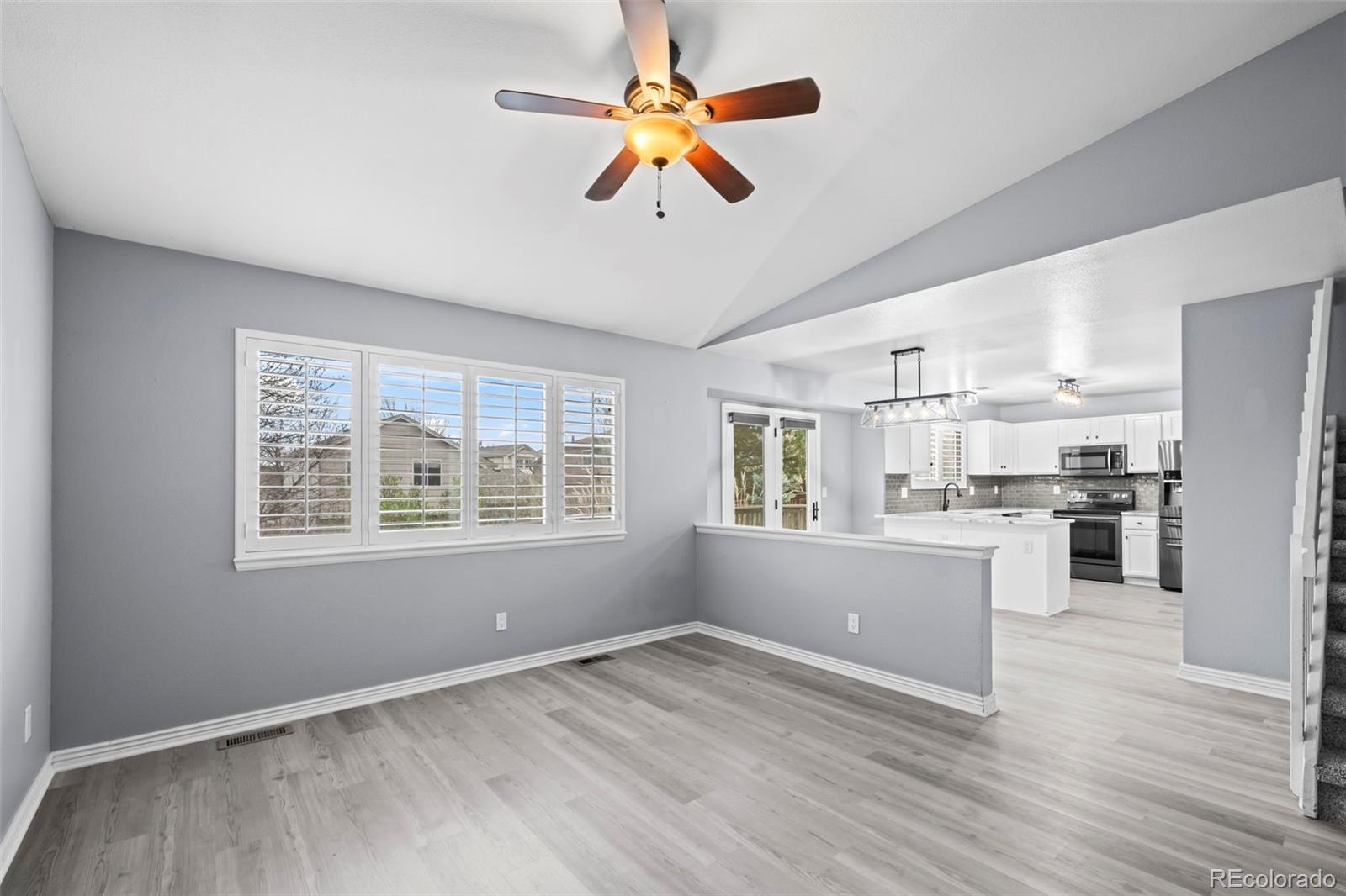 9664 Whitecliff Place Highlands Ranch, CO 80129 - Photo 8 of 46 a view of an empty room with window and wooden floor