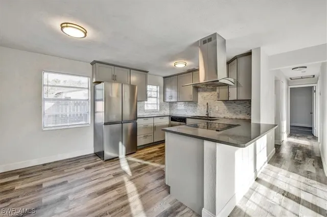 a kitchen with granite countertop a sink stove and refrigerator