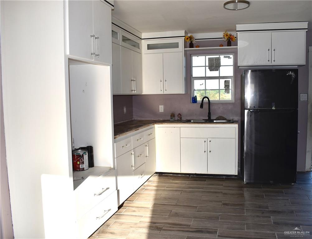 20842 Bohemia Street Edcouch, TX 78538 - Photo 5 of 8 a kitchen with a sink a refrigerator and cabinets