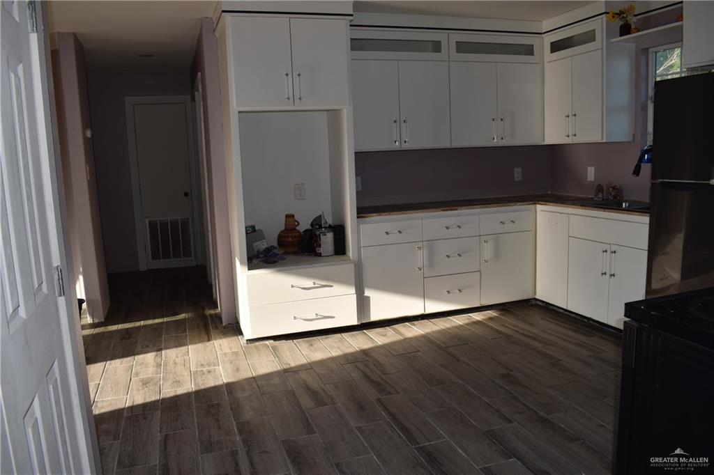 20842 Bohemia Street Edcouch, TX 78538 - Photo 7 of 8 a kitchen with a stove and a refrigerator