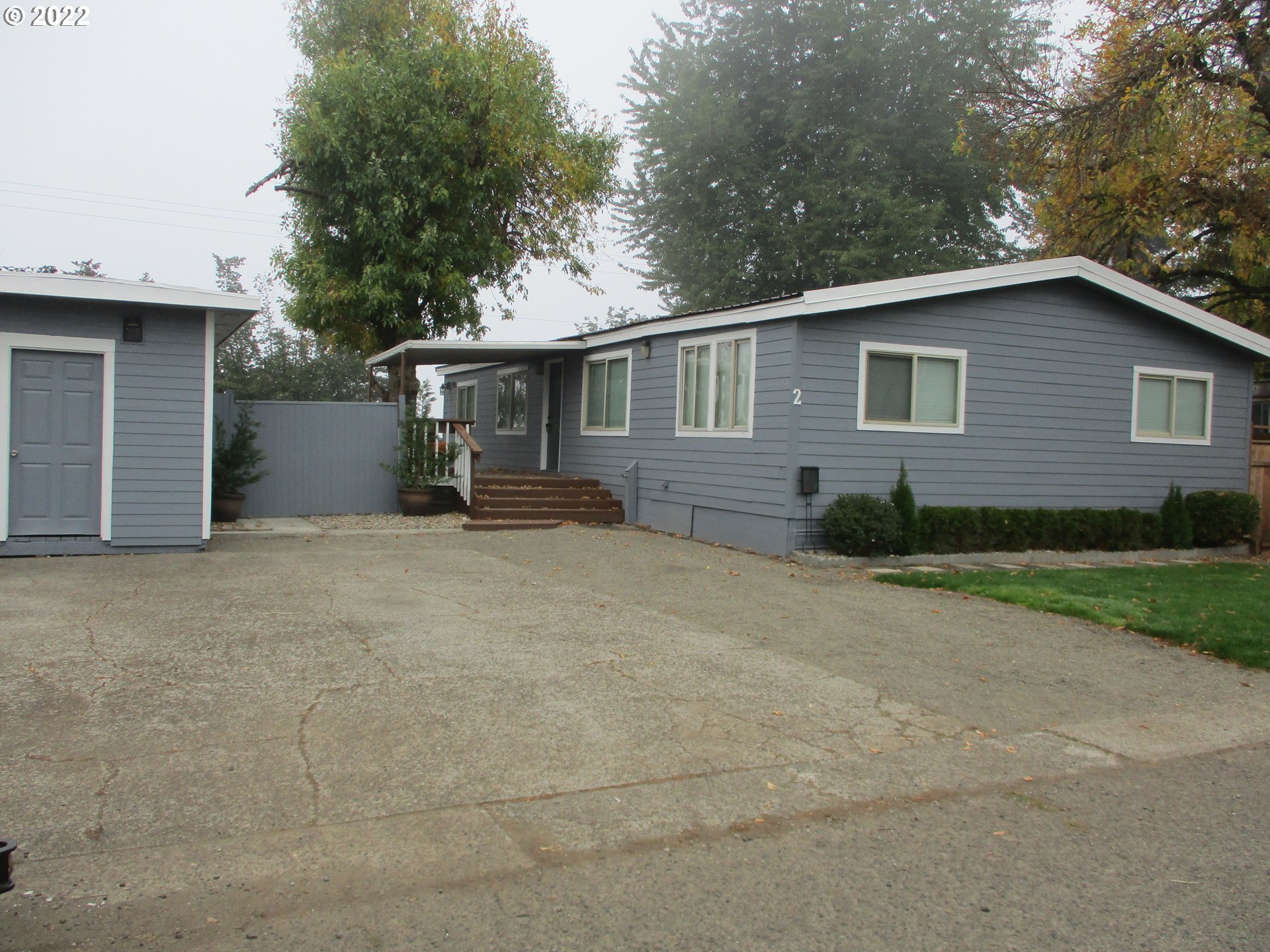 10038 South New Era Road, Unit 2 Canby, OR 97013 - Photo 1 of 20 a view of a house with a yard and large tree