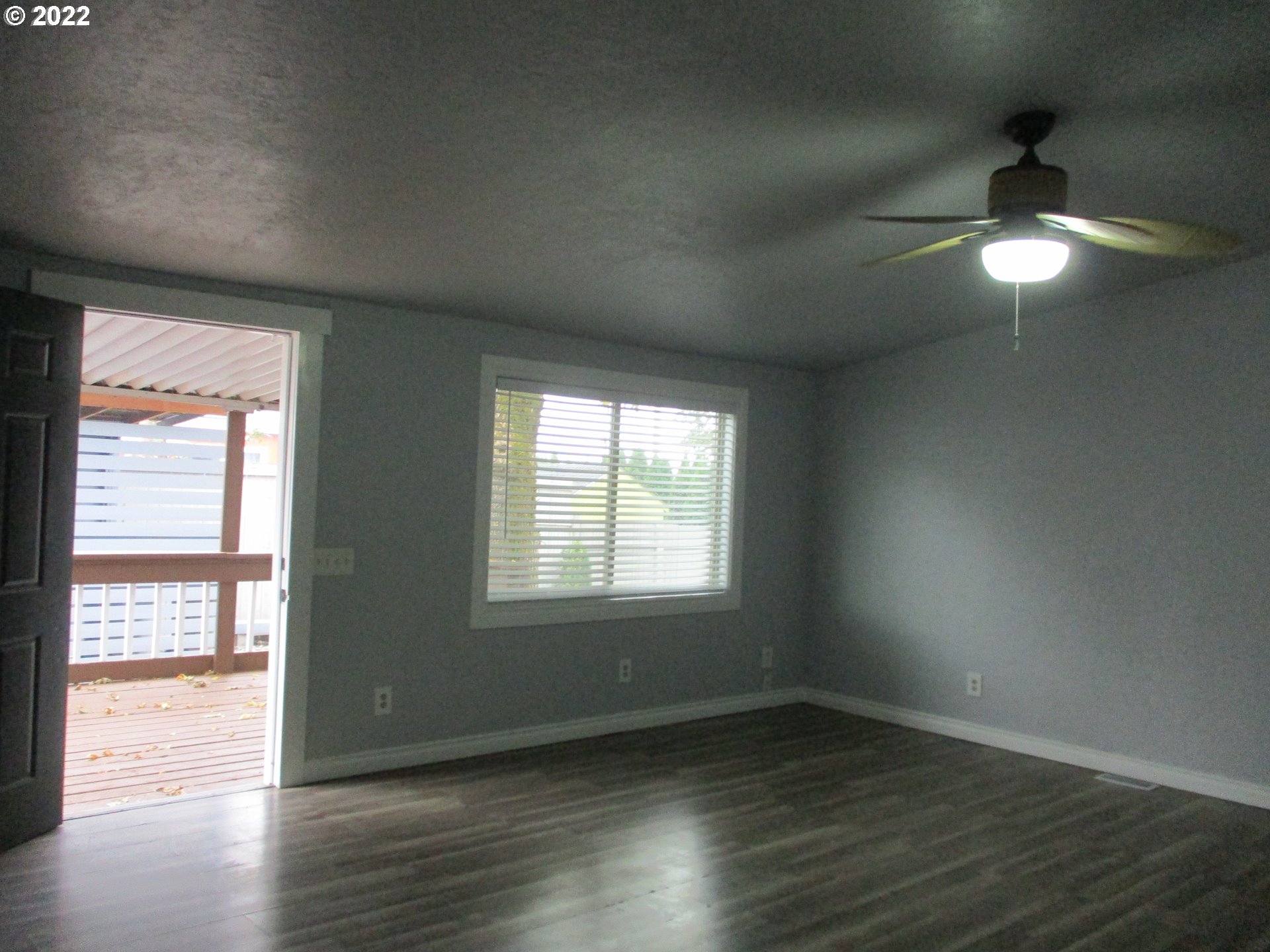 10038 South New Era Road, Unit 2 Canby, OR 97013 - Photo 11 of 20 an empty room with wooden floor and windows