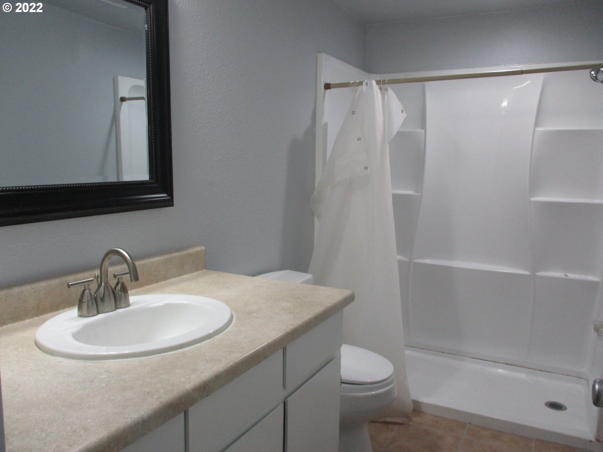 10038 South New Era Road, Unit 2 Canby, OR 97013 - Photo 12 of 20 a bathroom with a sink a toilet and shower