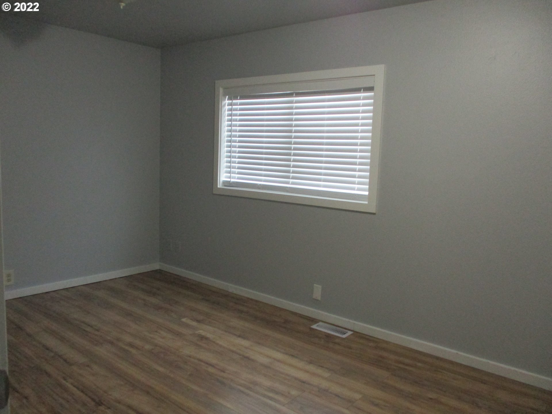 10038 South New Era Road, Unit 2 Canby, OR 97013 - Photo 13 of 20 wooden floor and window in an empty room
