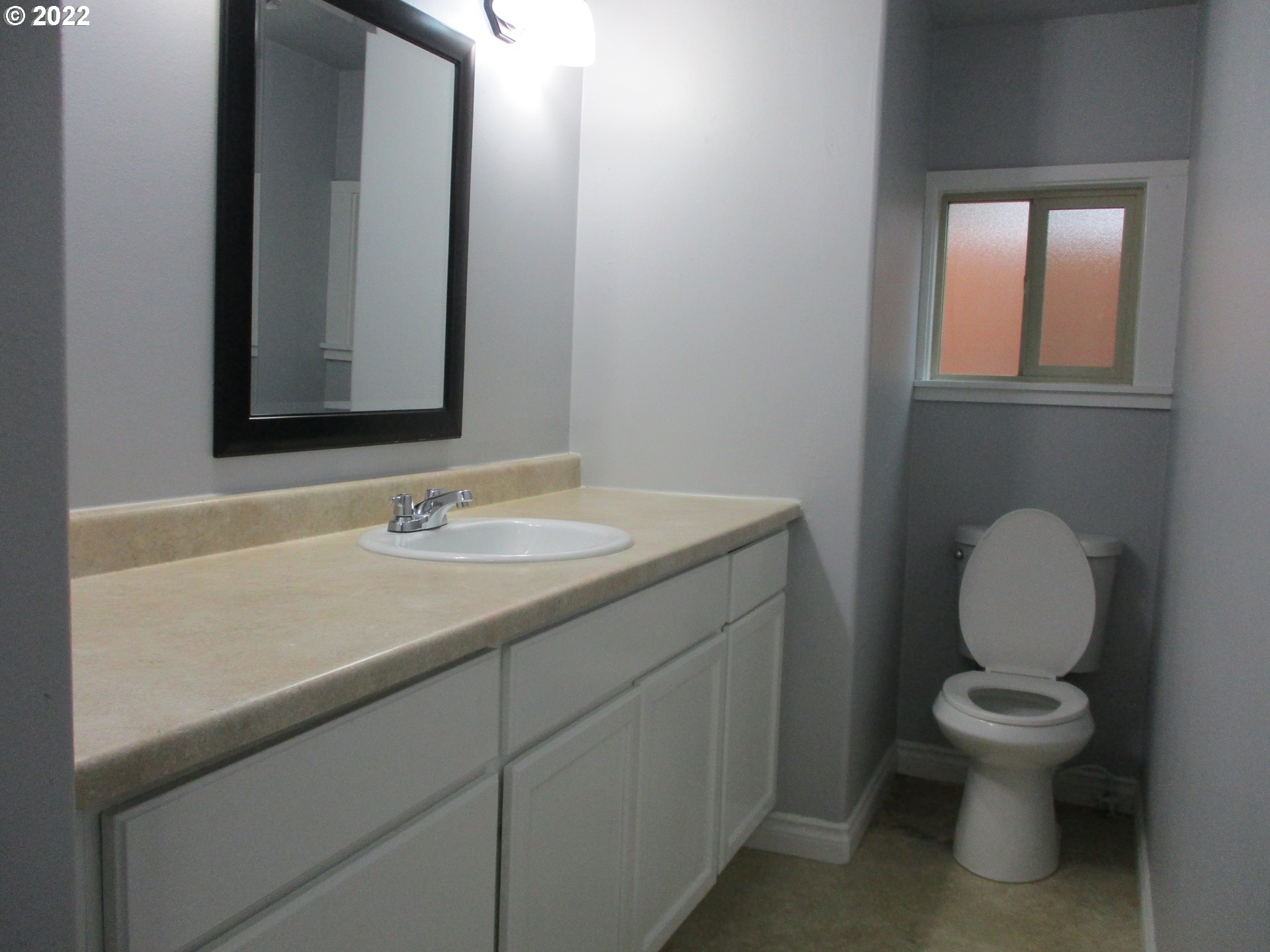 10038 South New Era Road, Unit 2 Canby, OR 97013 - Photo 6 of 20 a bathroom with a toilet sink vanity and mirror