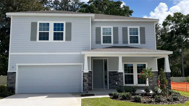 a view of a house with brick walls and a large window
