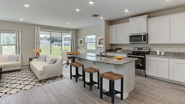 a kitchen with a sink cabinets and wooden floor