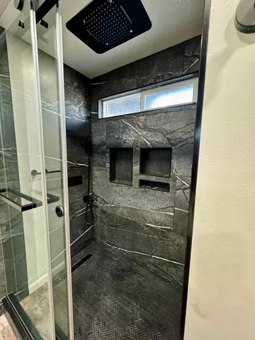 a bathroom with a shower and a sink