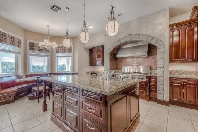a kitchen with stainless steel appliances granite countertop a stove and a sink