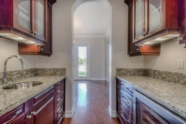 a kitchen with a sink stove and cabinets