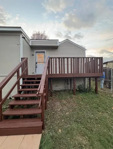 a view of a house with wooden deck