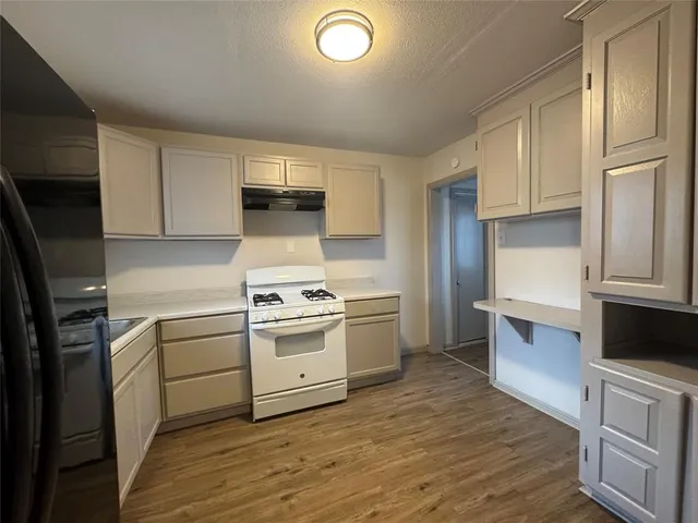 a kitchen with a sink cabinets and stainless steel appliances