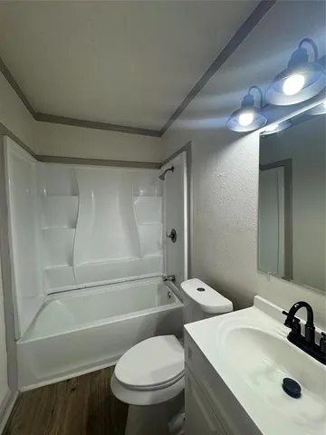 a bathroom with a toilet sink and shower