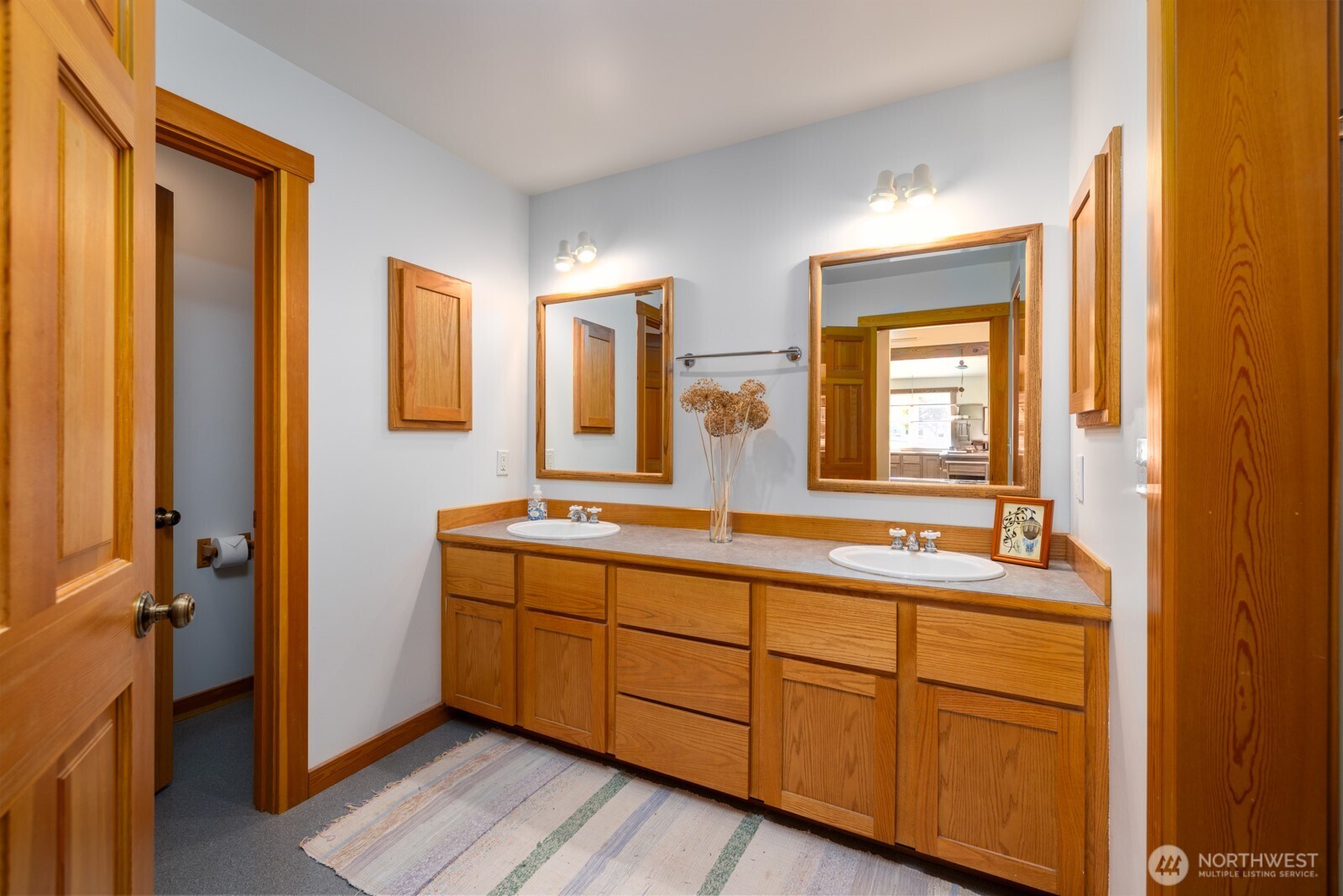 68 Sylvan Cove W Road Decatur Island, WA 98221 - Photo 18 of 35 a bathroom with a double vanity sink and mirror