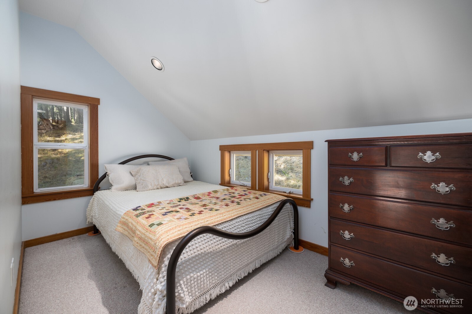 68 Sylvan Cove W Road Decatur Island, WA 98221 - Photo 19 of 35 a bedroom with a bed a lamp and window