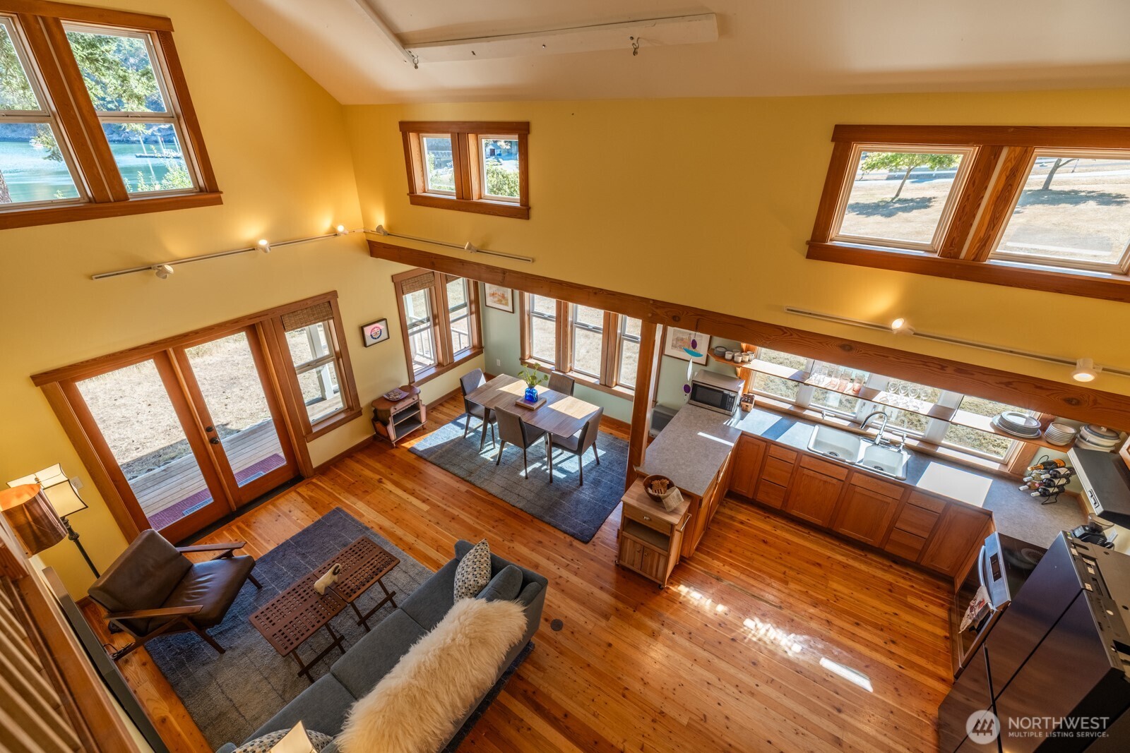 68 Sylvan Cove W Road Decatur Island, WA 98221 - Photo 21 of 35 a living room with furniture and a floor to ceiling window