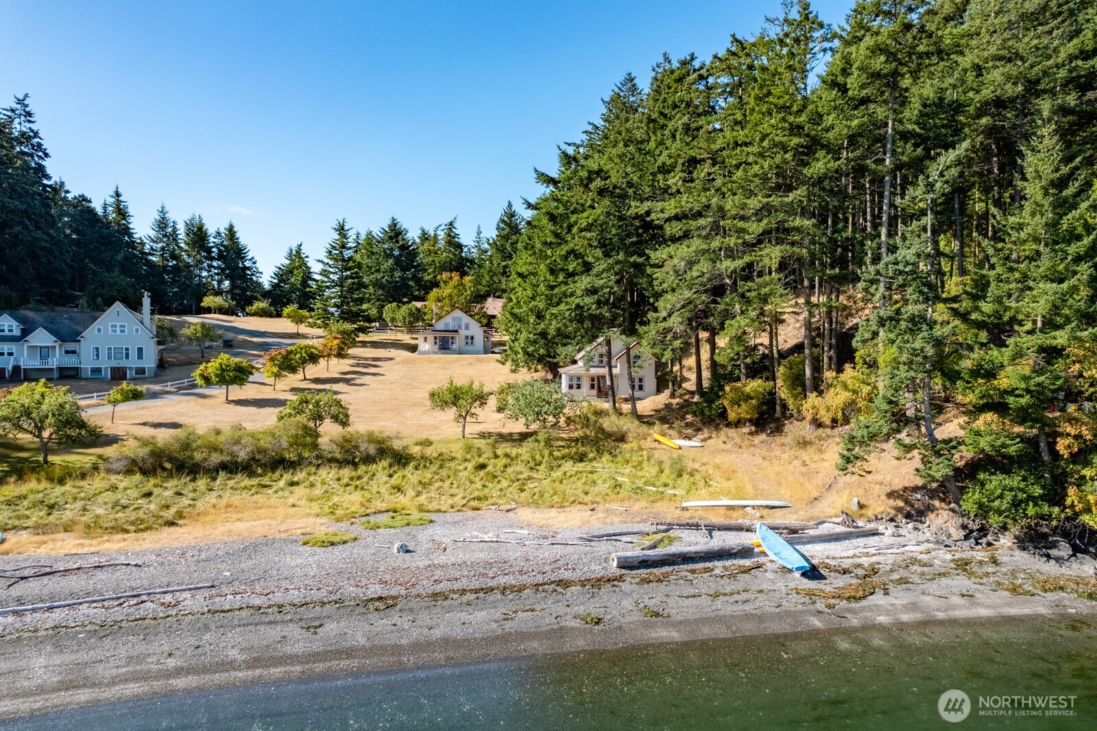 68 Sylvan Cove W Road Decatur Island, WA 98221 - Photo 4 of 35 a view of a yard with wooden fence