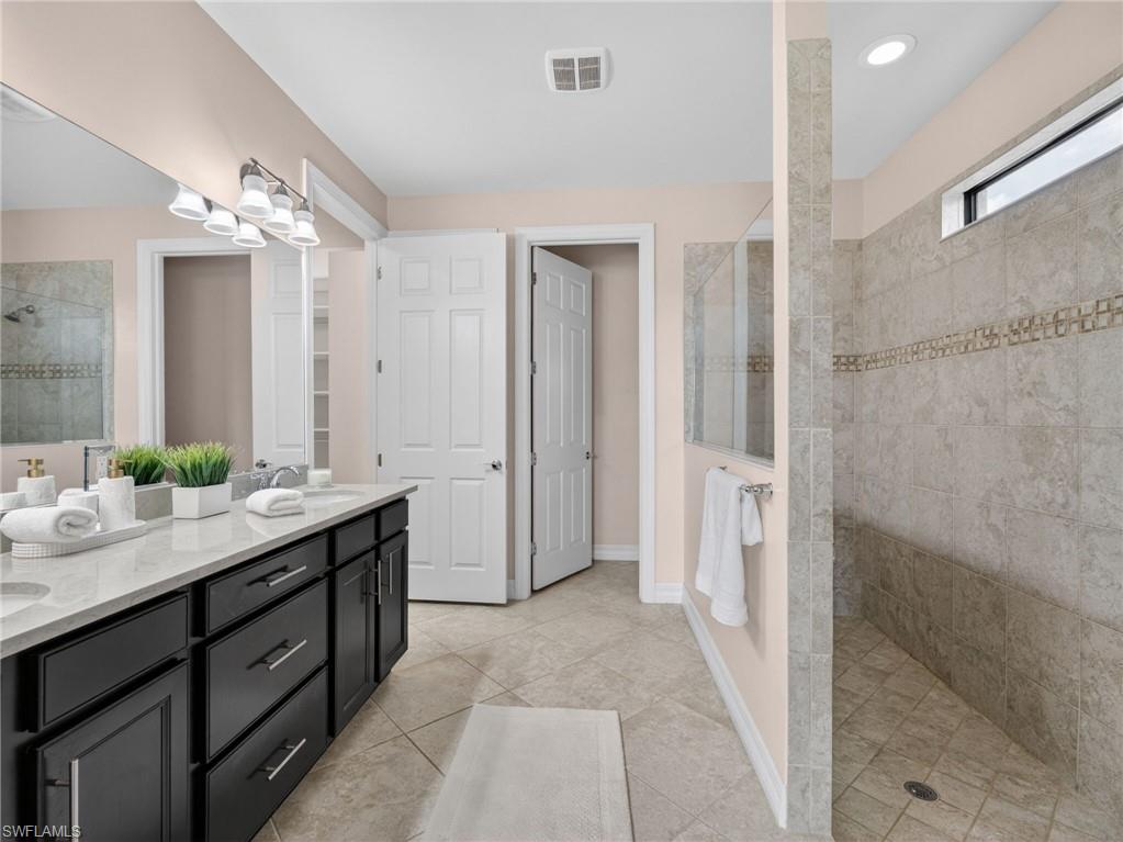 6124 Victory Drive Ave Maria, FL 34142 - Photo 28 of 50 a spacious bathroom with a double vanity sink mirror and shower