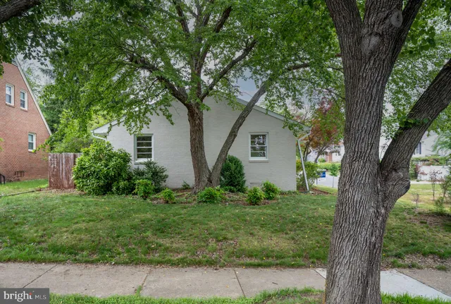 a view of house with yard and green space