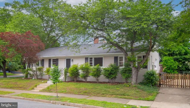 a view of a backyard with wooden fence