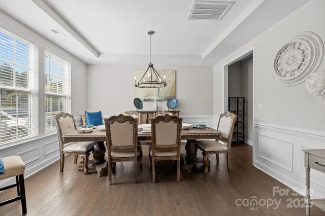 a spacious bedroom with a bed and a lamp