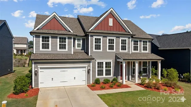 a kitchen with stainless steel appliances kitchen island granite countertop a table chairs and white cabinets