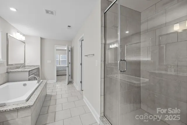 a spacious bedroom with a bed and a window