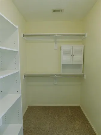a view of an empty walk in closet